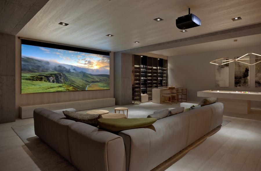 A casual home theater with a sectional, Sony projector, large movie screen, and a pool table.